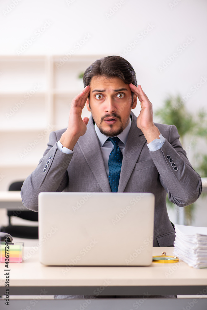 Young male employee working in the office Young male employee working in the office