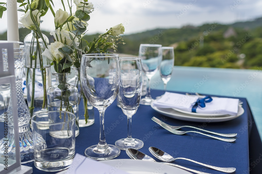 Blue and Silver Romantic Wedding Table Top Layout Table Spread no people catering, event, decor in a tropical location with the sea and clouds in the background Blue and Silver Romantic Wedding Table Top Layout Table Spread no people catering, event, decor in a tropical location with the sea and clouds in the background
