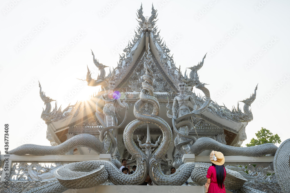 Sisaket, Thailand - 6 April 2021: Art on Naga on a Thai temple pavilion. Tourists visiting Thai temples, Sisaket Province, Thailand.