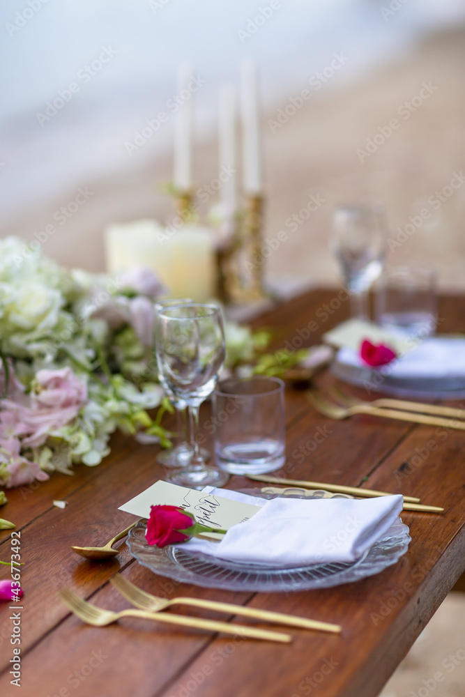 Romantic Wedding Table Top for Two 2 people Layout Table Spread no people tropical beach location with gold cutlery and scenic view of sunset on the beach soft light Romantic Wedding Table Top for Two 2 people Layout Table Spread no people tropical beach location with gold cutlery and scenic view of sunset on the beach soft light