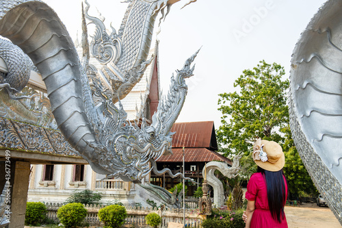 Sisaket, Thailand - April 6, 2021: Female tourist visits Thai temple, Sisaket, Thailand. photo