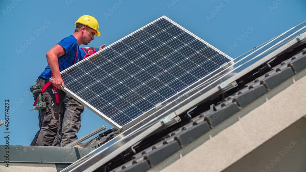 Two caucasian worker installing modern photovoltaic system on rooftop during sunlight Two caucasian worker installing modern photovoltaic system on rooftop during sunlight