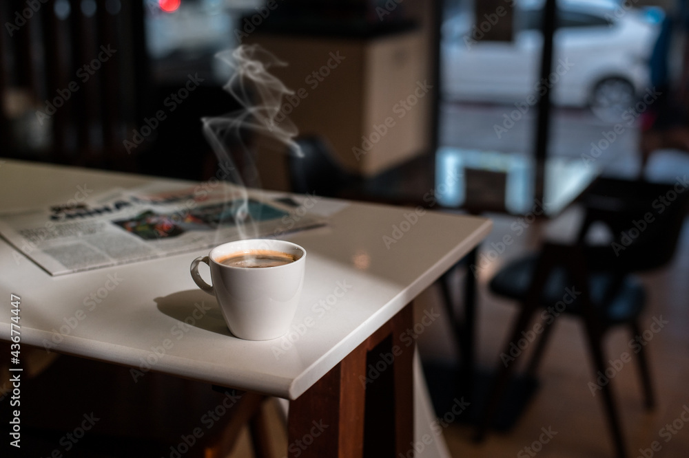 White coffee mug on the table inside the cafe White coffee mug on the table inside the cafe