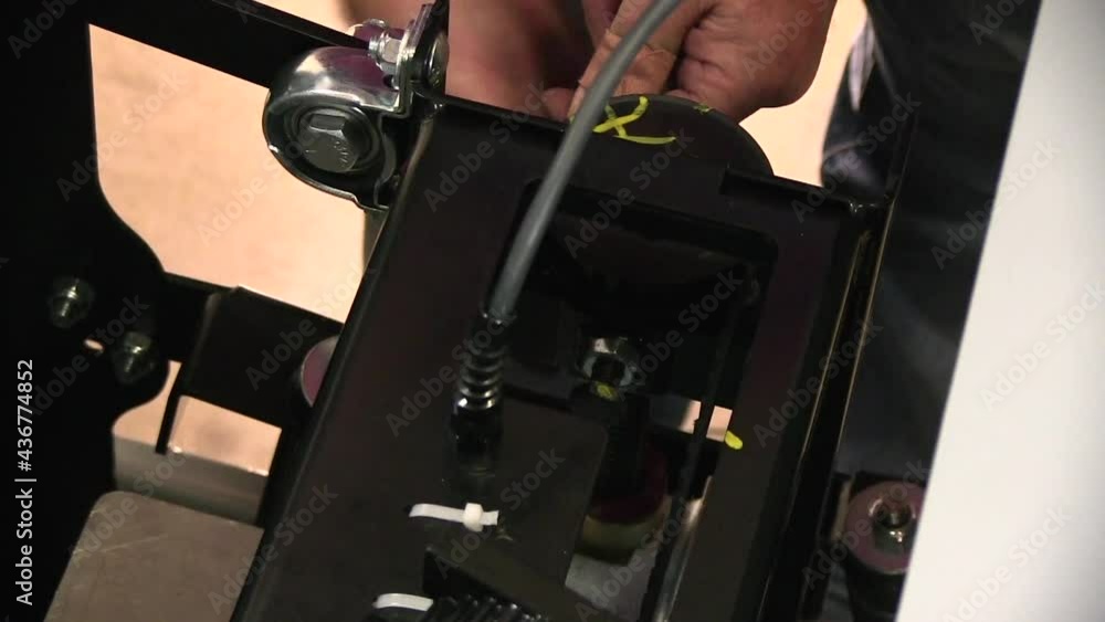 Tightening the belt on a paint mixer with a wrench close up Tightening the belt on a paint mixer with a wrench close up