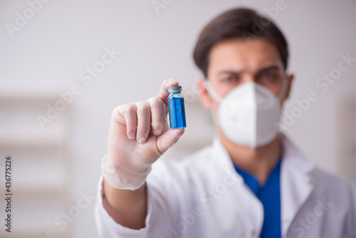Young male doctor in vaccination concept