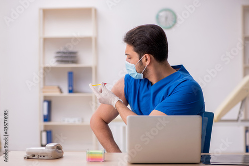 Young male doctor in vaccination concept