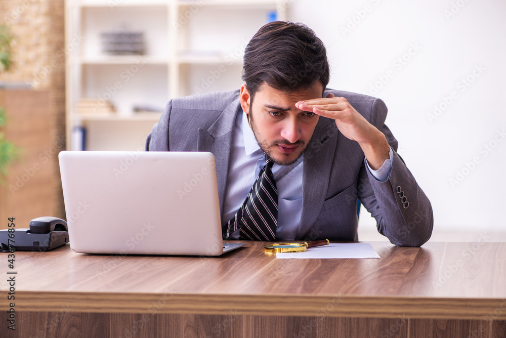 Young handsome businessman employee working in the office Young handsome businessman employee working in the office