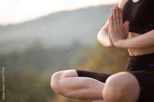 Close up with selective focus of yogi young woman practicing yoga exercises, breathing, meditating, Lotus pose with mudra gesture, working out. Wellbeing, wellness concept