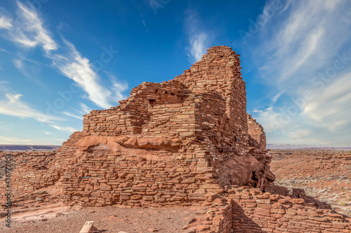 Wupatki National Monument located in north-central Arizona, near Flagstaff. Native American archaeological hilltop dwelling sites made from red stone built by ancient Sinagua pueblo people, blue sky