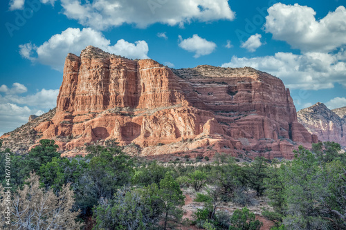 Aerial view of famous Sedona red rock formations: cathedral rock, bell rock, courthouse butte in Arizona with blue cloudy sky