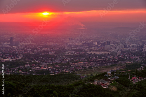 Magical atmosphere of the sunset over the evening city  Almaty town in Kazakhstan