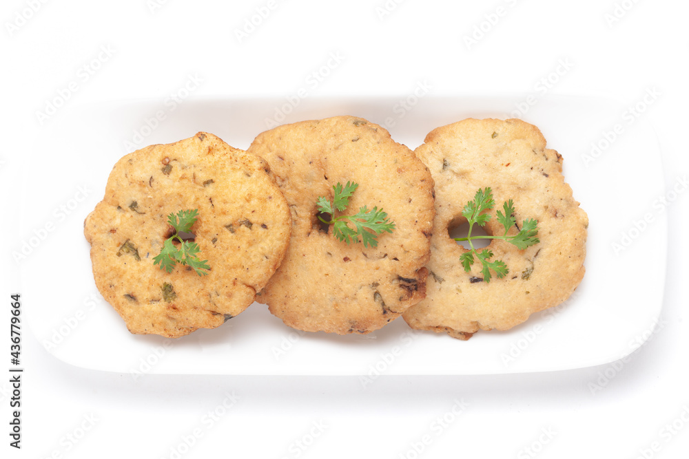 Plain dry three-piece Dahi badhe for preparation of chaat, Garnished with cumin and green fresh coriander in a white plate. Plain dry three-piece Dahi badhe for preparation of chaat, Garnished with cumin and green fresh coriander in a white plate.