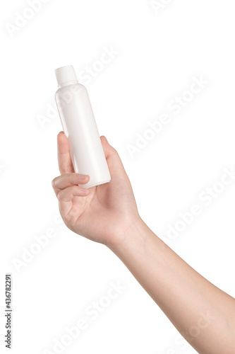 Woman hand holding a white plastic bottle on white background 