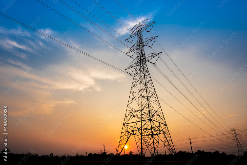 Electric poles and lines at dusk or high voltage towers at beautiful sky