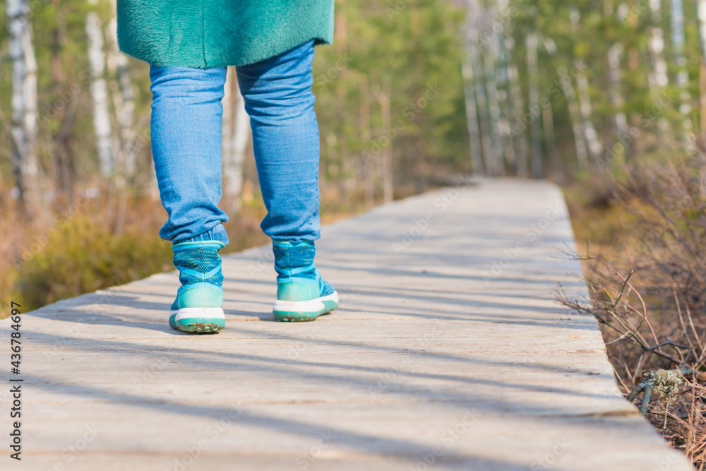 Close up woman walk in to the wild. Travel adventure and freedom concept.Woman walking outdoors, shoes closeup Close up woman walk in to the wild. Travel adventure and freedom concept.Woman walking outdoors, shoes closeup