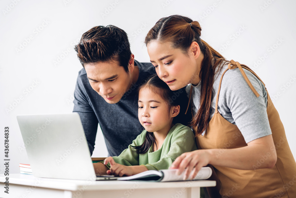 Portrait enjoy happy smiling love asian family father and mother with little asian girl learning and looking at laptop computer studying with online education e-learning system with teacher at home Portrait enjoy happy smiling love asian family father and mother with little asian girl learning and looking at laptop computer studying with online education e-learning system with teacher at home