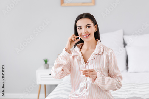 Beautiful young woman takin...