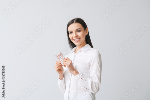 Beautiful young woman takin...