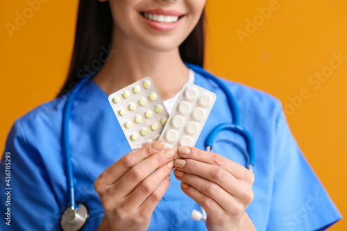 Female doctor with pills on...