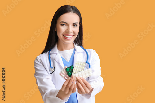 Female doctor with pills on...