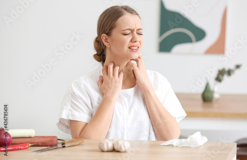 Young woman with food allergy in kitchen photo