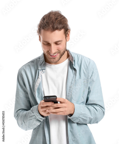 Young man using mobile phone on white background © Pixel-Shot