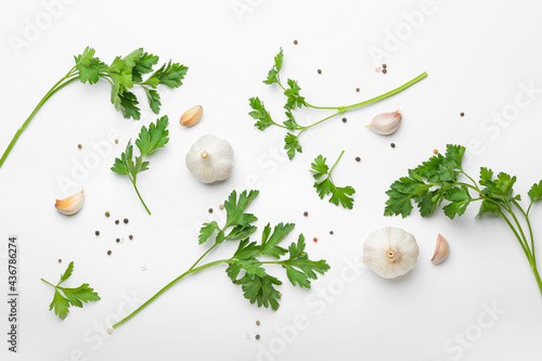 Fresh parsley with garlic on white background