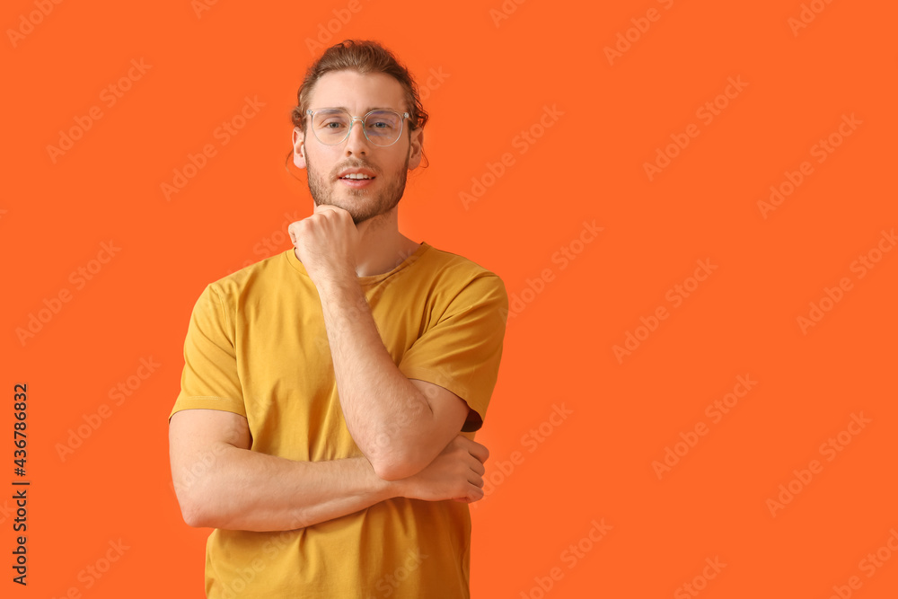 Young man wearing eyeglasses on color background Young man wearing eyeglasses on color background