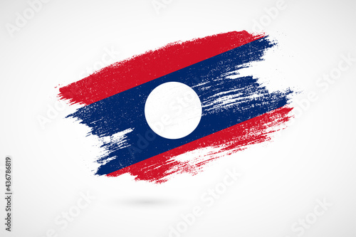Happy independence day of Laos with vintage style brush flag background