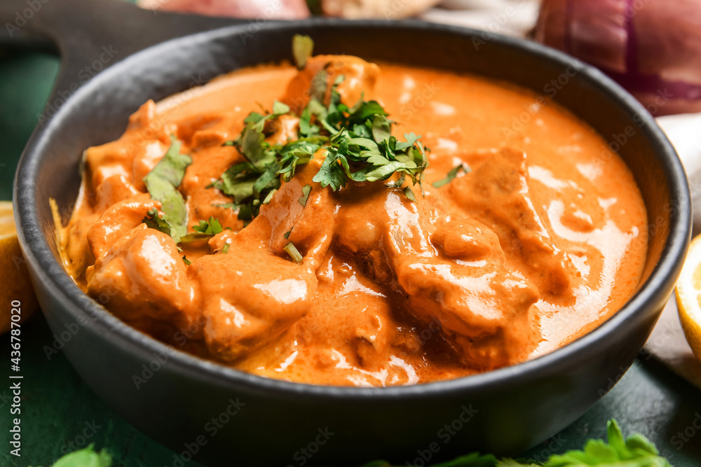 Frying pan of tasty chicken tikka masala on table, closeup Frying pan of tasty chicken tikka masala on table, closeup