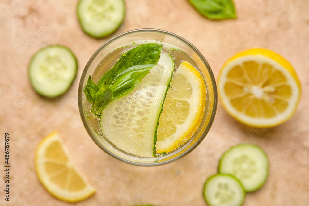Glass with cucumber lemonade on color background Glass with cucumber lemonade on color background