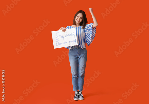Young woman holding poster ...