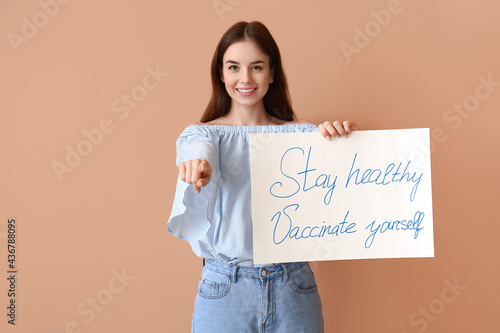 Young woman holding poster ...