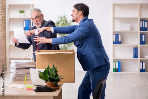 Two male employees in dismissal concept