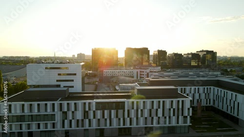 Aerial truck camera durning sunrise close up University of Gdansk, modern building with steel and glass Poland photo