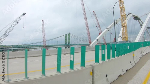 POV while driving thru construction zone with oncoming traffic on other side of concrete barrier; new arch bridge over Mississippi River on Interstate 74 between Moline IL and Bettendorf IA photo