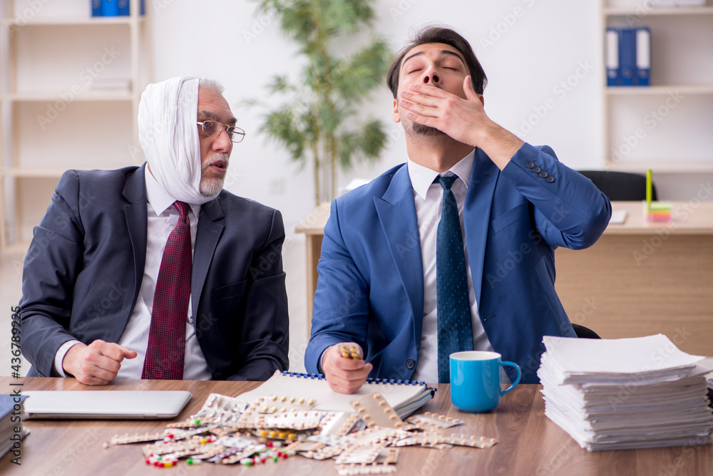 Old male employee suffering from toothache in the office Old male employee suffering from toothache in the office