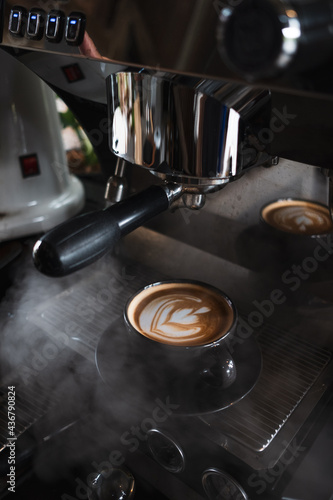 Cup of cappuccino on a wooden table, close up 