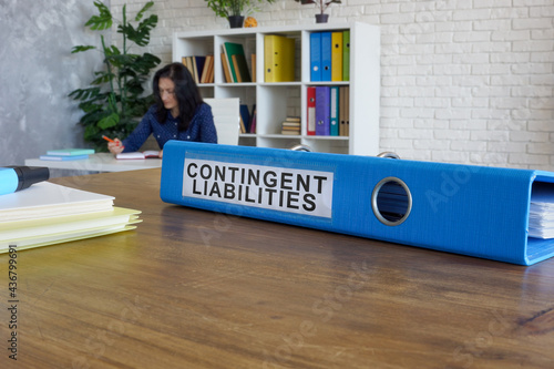 Blue folder with label contingent liabilities on desk.