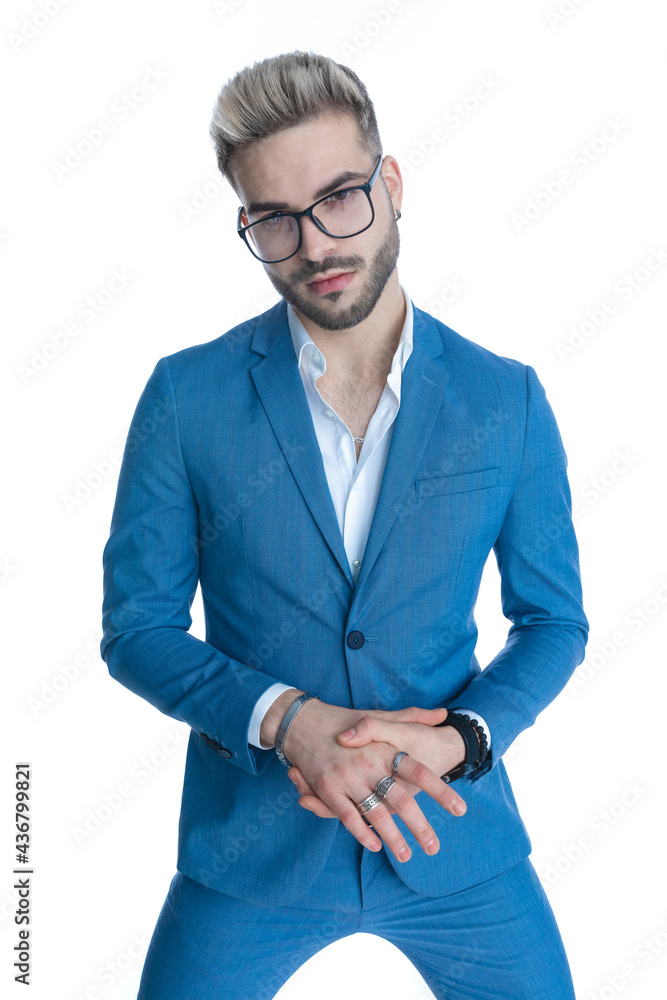 sexy nerdy businessman in blue suit with glasses holding hands together sexy nerdy businessman in blue suit with glasses holding hands together