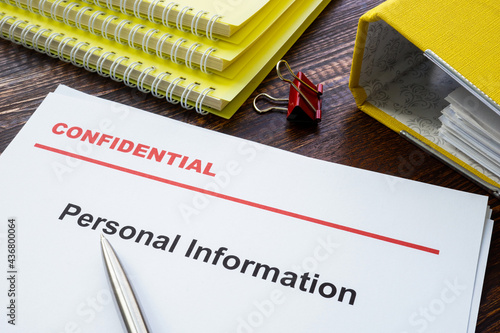 Obraz na plátně Personal information documents with label confidential on top.