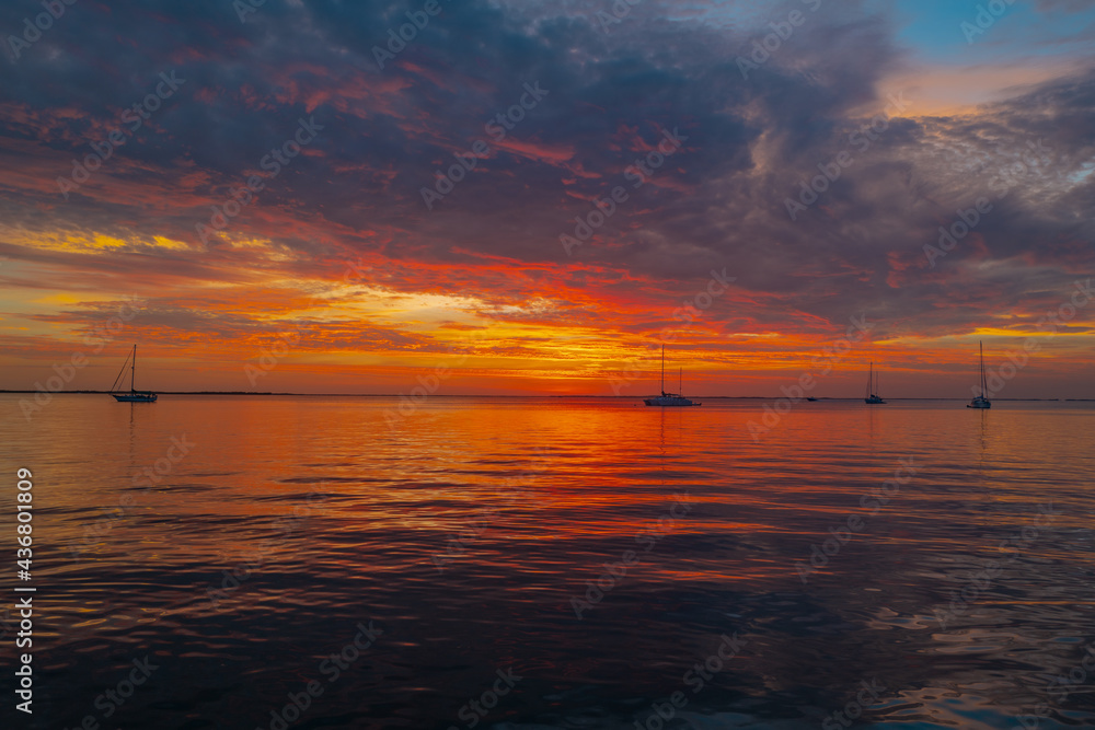 Seascape golden sunrise over the sea. Nature landscape. Beautiful orange and yellow color on ocean sunset. Seascape with gold sky and clouds. Seascape golden sunrise over the sea. Nature landscape. Beautiful orange and yellow color on ocean sunset. Seascape with gold sky and clouds.