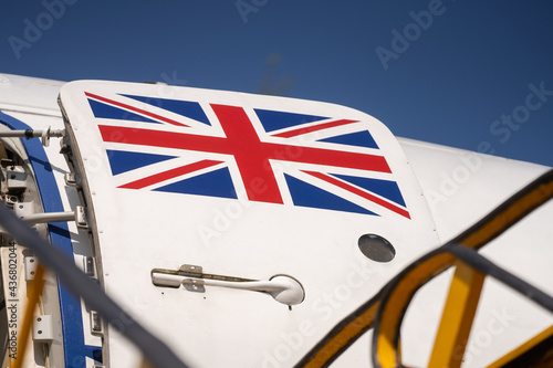 Print op canvas Union Jack flag painted on open door of decommissioned RAF troop transporter aeroplane