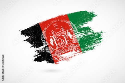 Happy independence day of Afghanistan with vintage style brush flag background