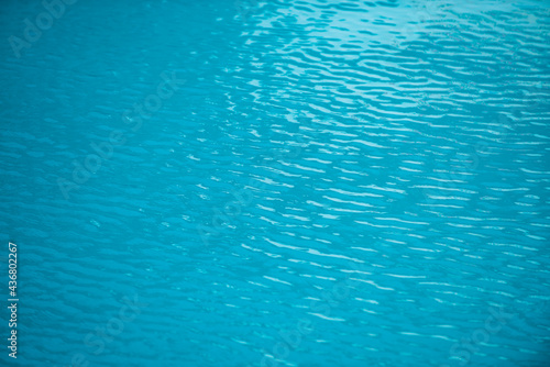 Water in swimming pool, background with high resolution. Wave abstract or rippled water texture.