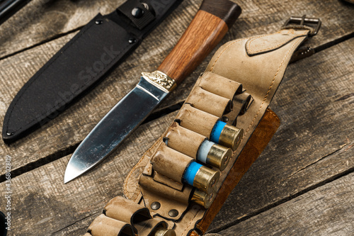 Various hunting equipment on old wooden background