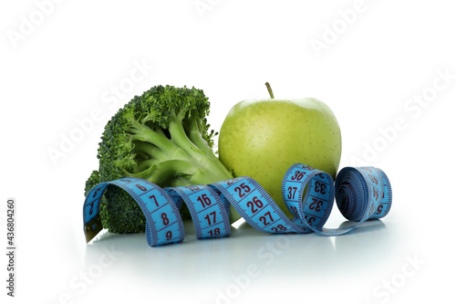 Broccoli, apple and measuring tape isolated on white background