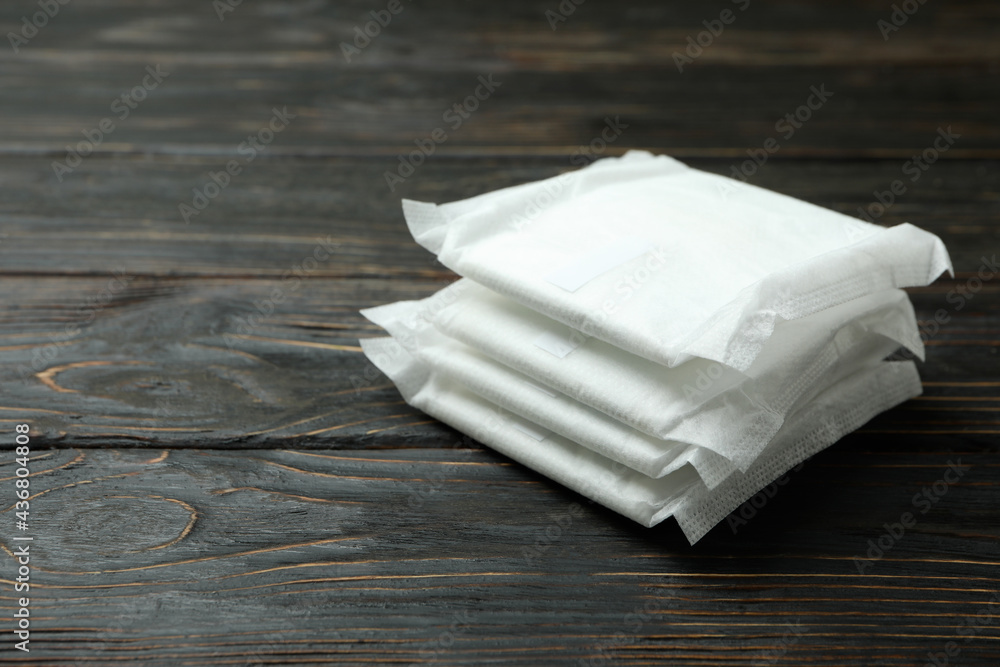 Stack of sanitary pads on wooden background Stack of sanitary pads on wooden background