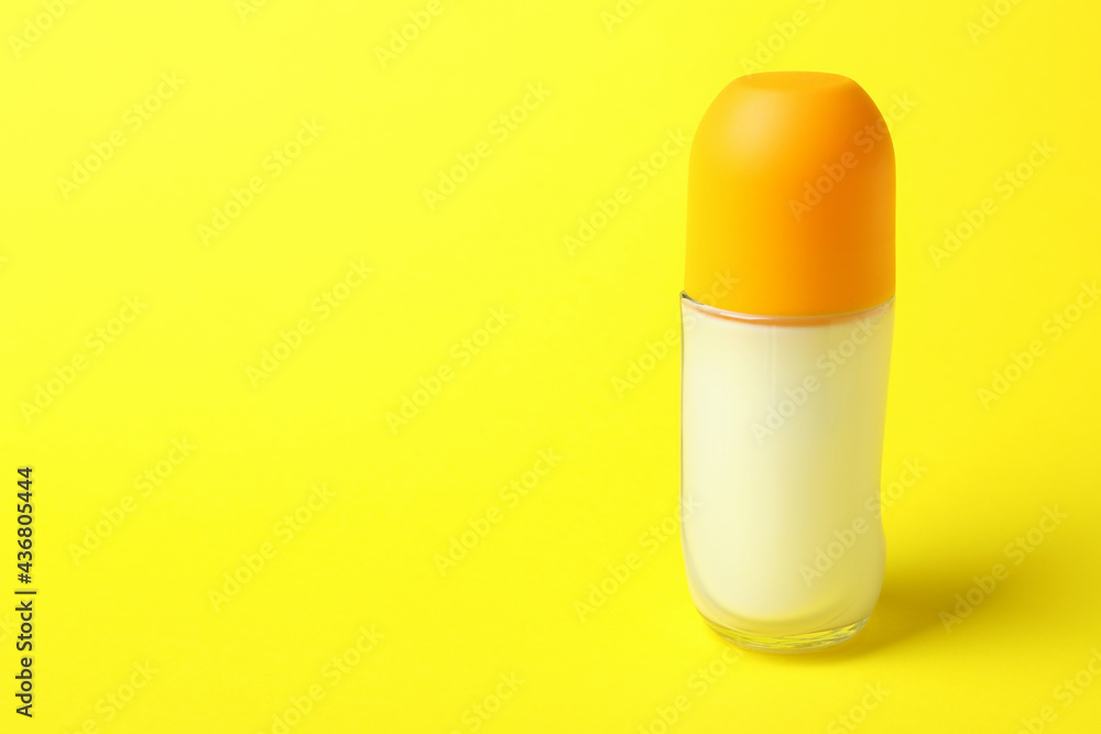 Blank roll-on deodorant on yellow background, space for text Blank roll-on deodorant on yellow background, space for text