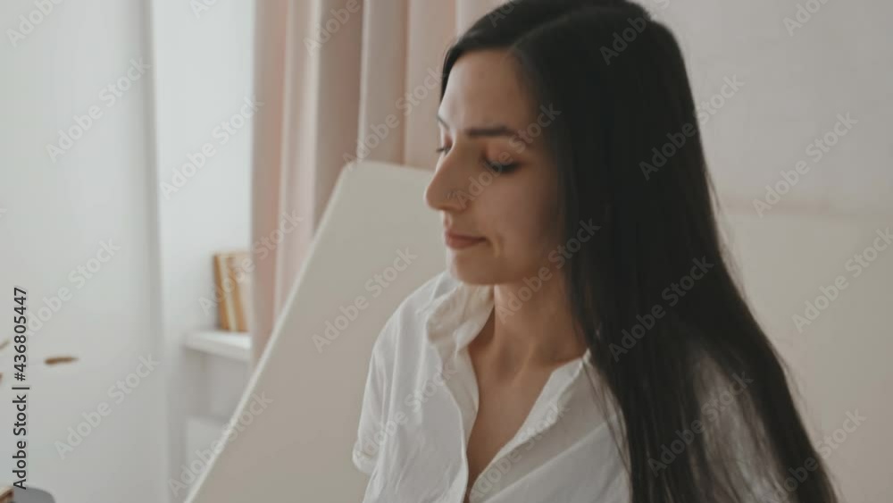 Close-up of young attractive woman of Latin ethnicity lying on white sheets in big comfortable bed then waking up and stretching after good sleep Close-up of young attractive woman of Latin ethnicity lying on white sheets in big comfortable bed then waking up and stretching after good sleep
